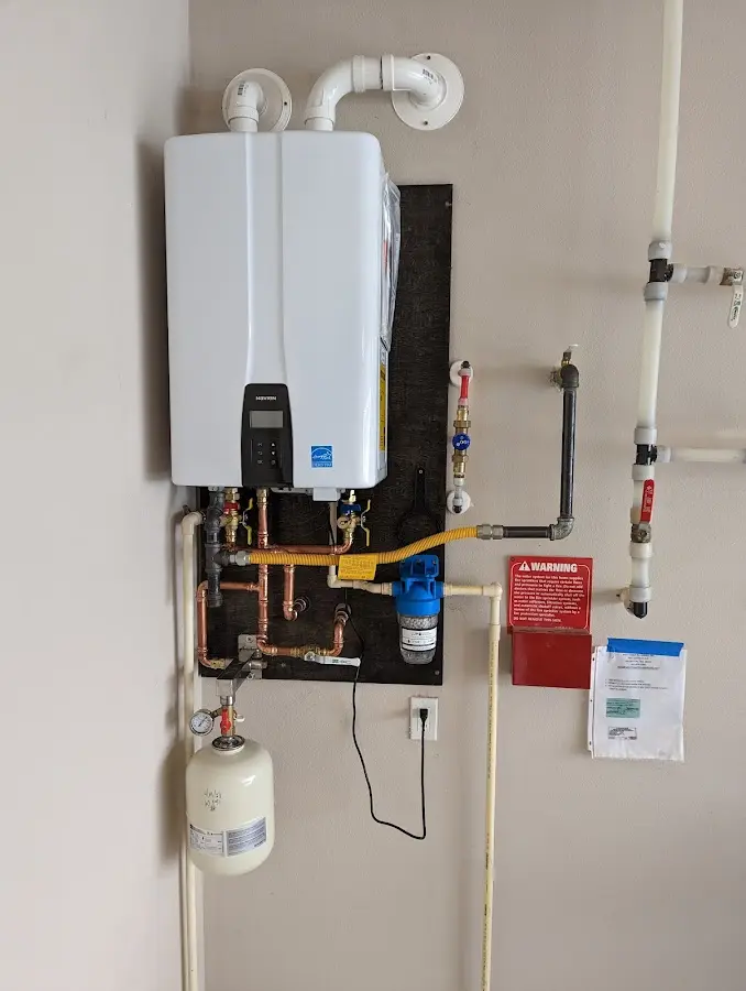 Professional plumber installing copper piping in a Marshall home